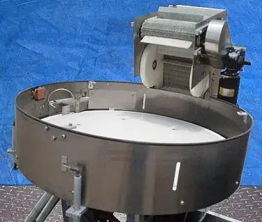 Alimentador de tapas de New England Machinery Company